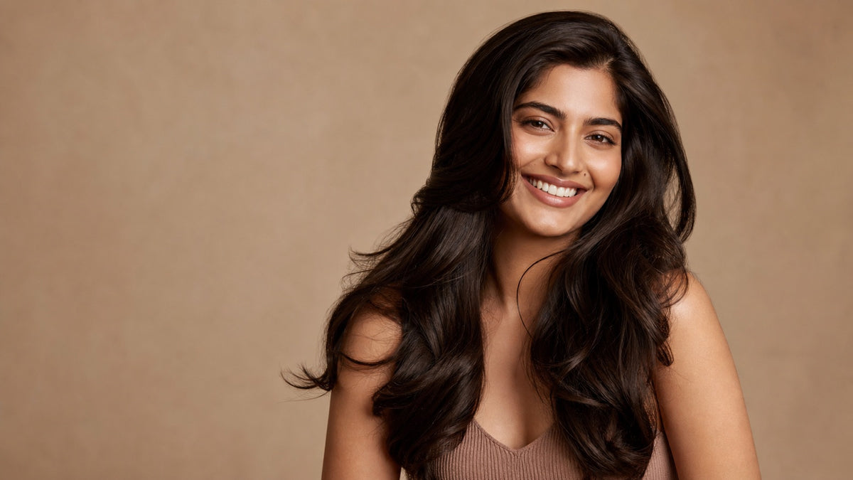 South Asian woman with long, healthy, glossy voluminous dark hair, warm editorial portrait