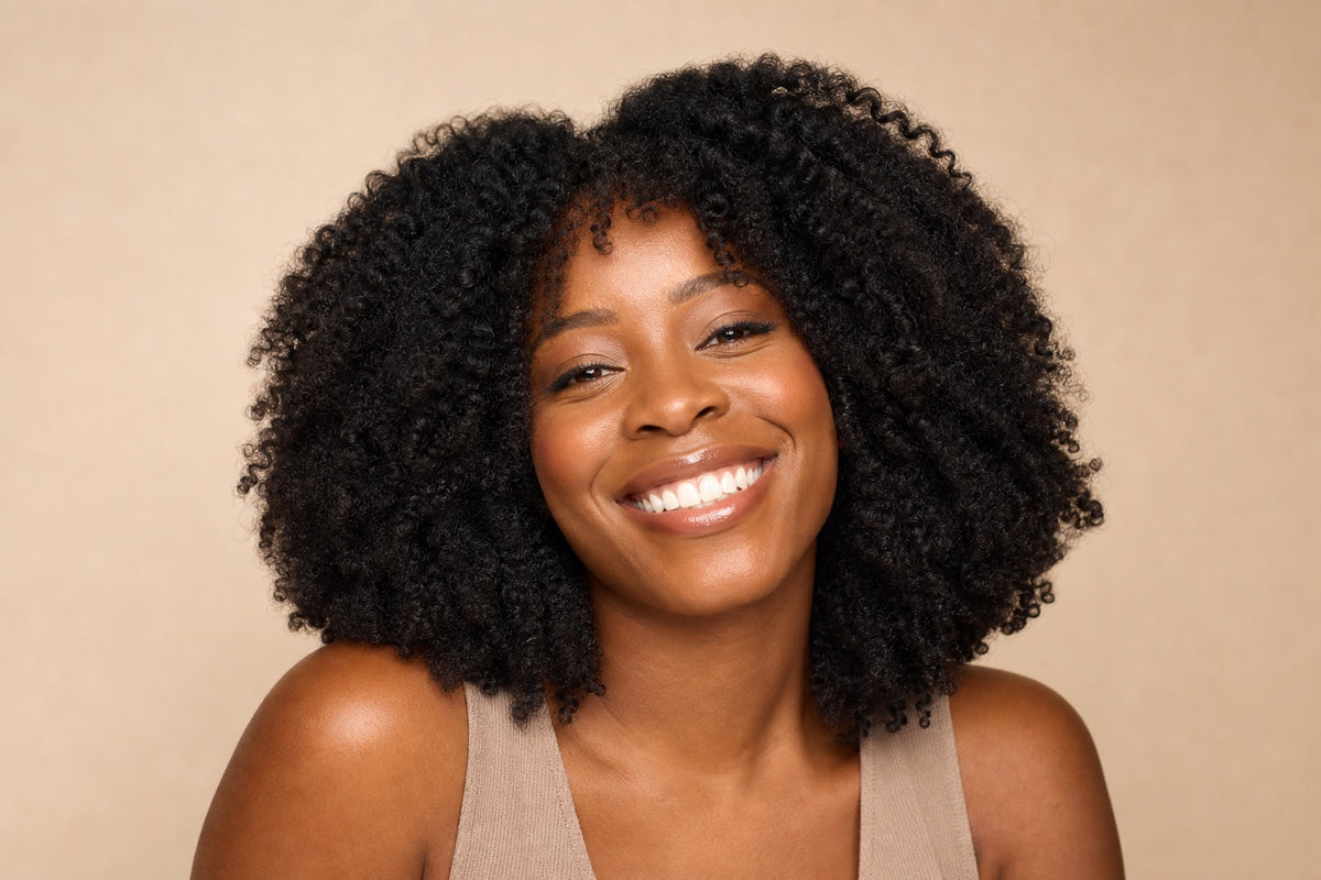 A joyful woman with healthy natural-texture curls.