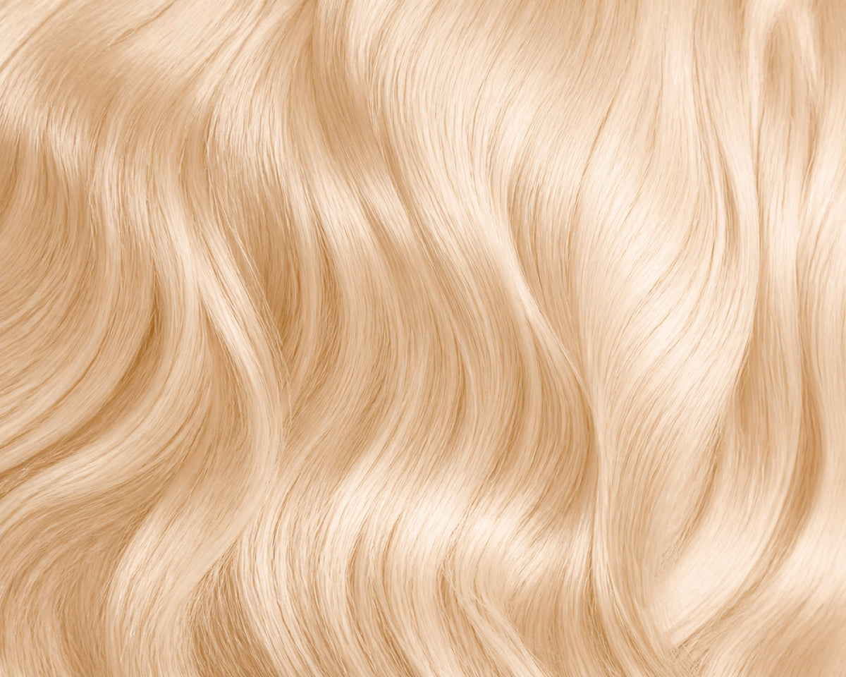 Macro of lifted blonde #613 human hair showing tone and texture.