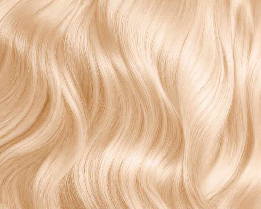Macro of lifted blonde #613 human hair showing tone and texture.