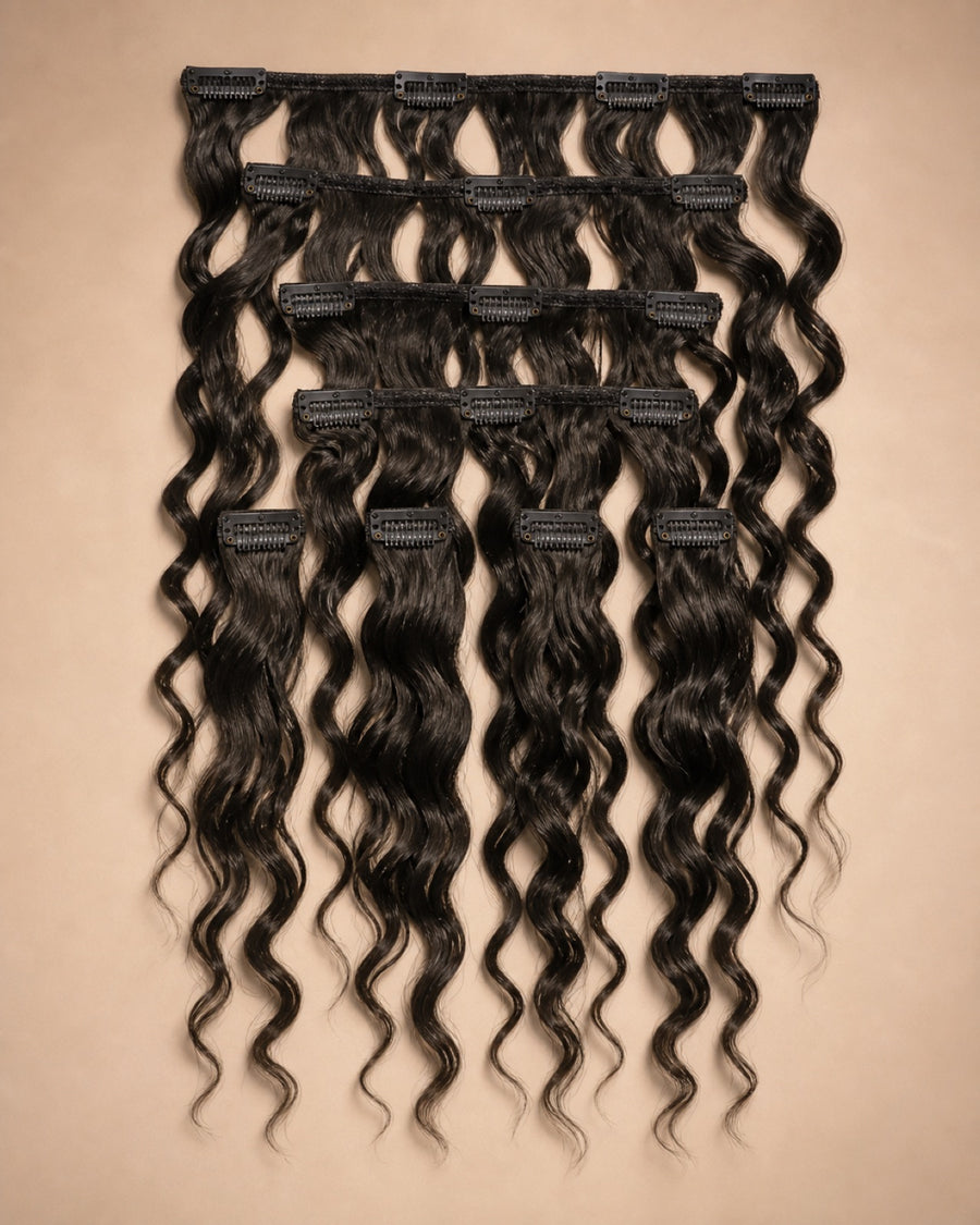 A flatlay of human hair extension wefts arranged as a set.