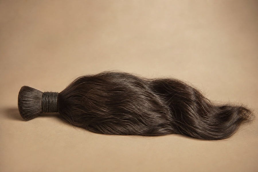 A coveted bundle of raw dark Indian temple hair with natural texture.