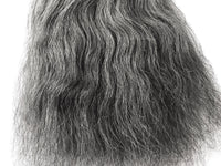 Close-up of salt and pepper grey human hair weft showing mixed grey and dark strands