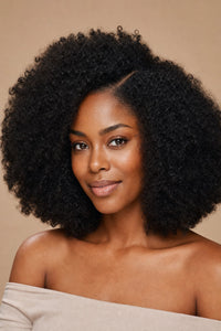 Black woman with natural afro coily hair and a clean part showing the achievable look