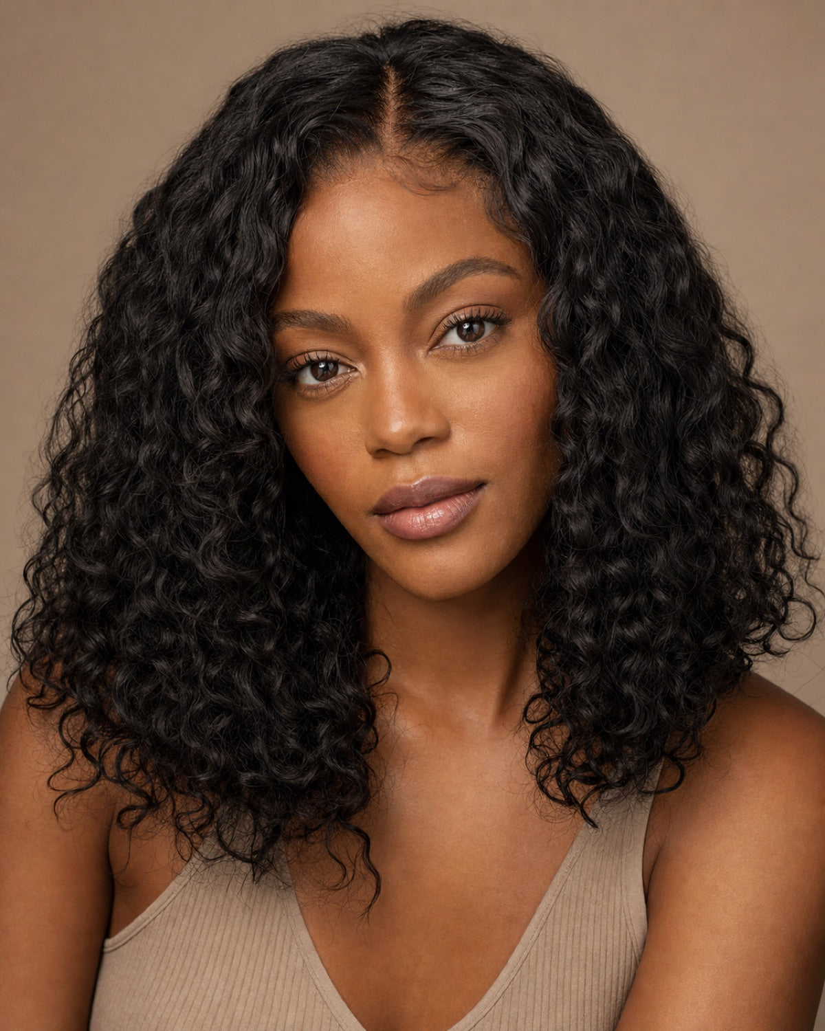 Model with natural-black loose-curly hair and a seamless natural part showing the achievable look