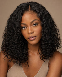 Model with natural-black loose-curly hair and a seamless natural part showing the achievable look