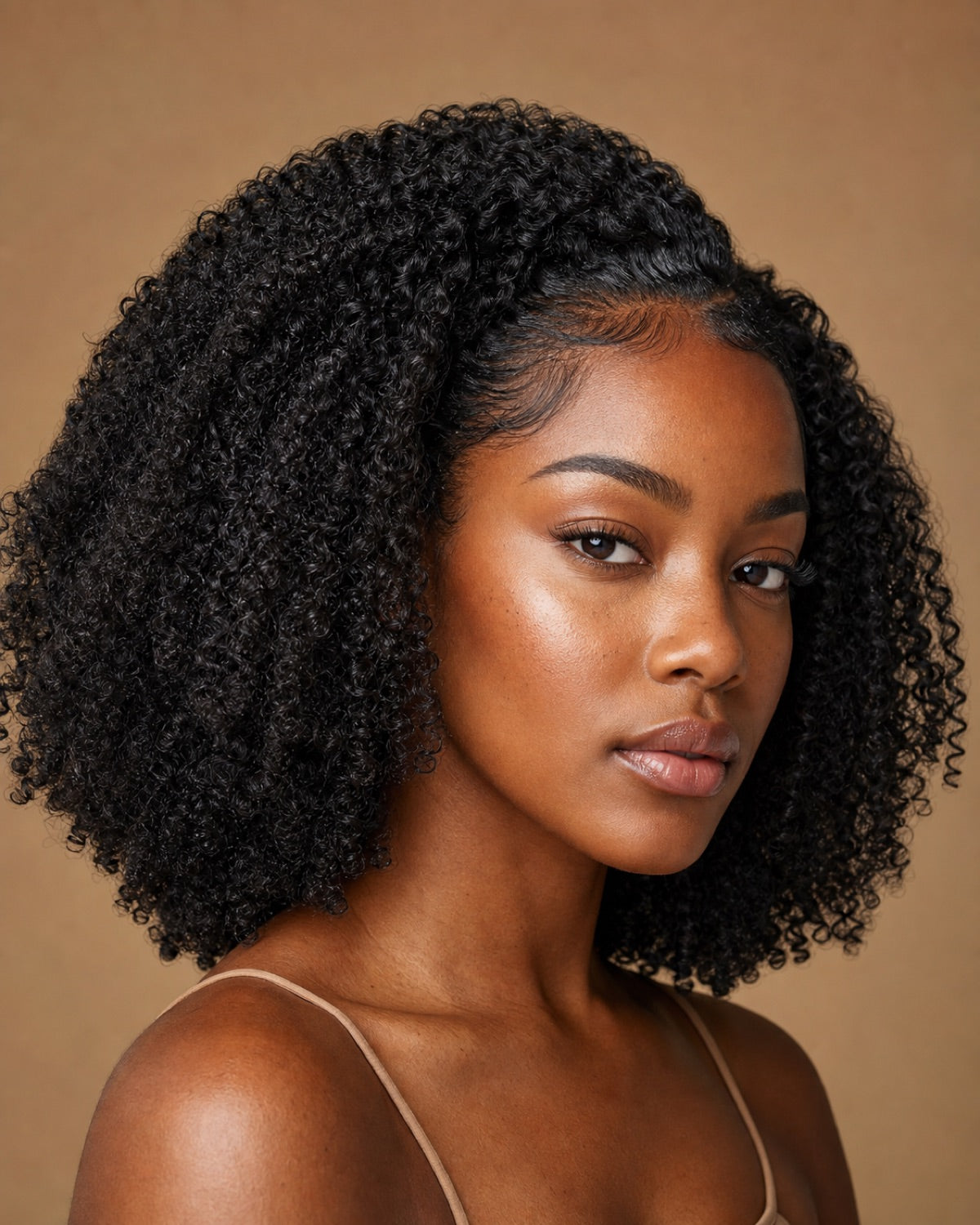 Black woman with natural-black kinky-curly hair and a flawless natural part, showing the achievable look