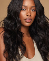 Model with long natural-black loose-wave Jackson wave hair, soft beachy waves