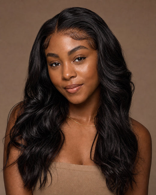 Model with glossy natural-black natural-wavy front-lace wig hair