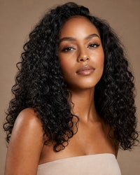 Model with glossy loose-curly natural-black hair past the shoulders