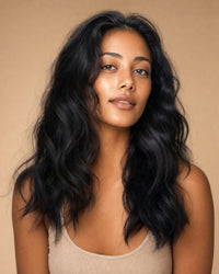 Model with natural-black, healthy natural-wavy hair and a natural hairline
