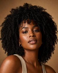 Model with voluminous kinky-curly natural black hair