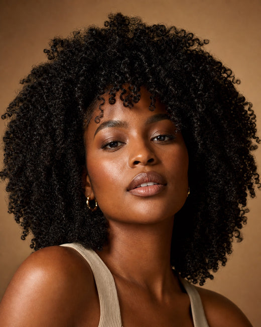 Model with voluminous kinky-curly natural black hair
